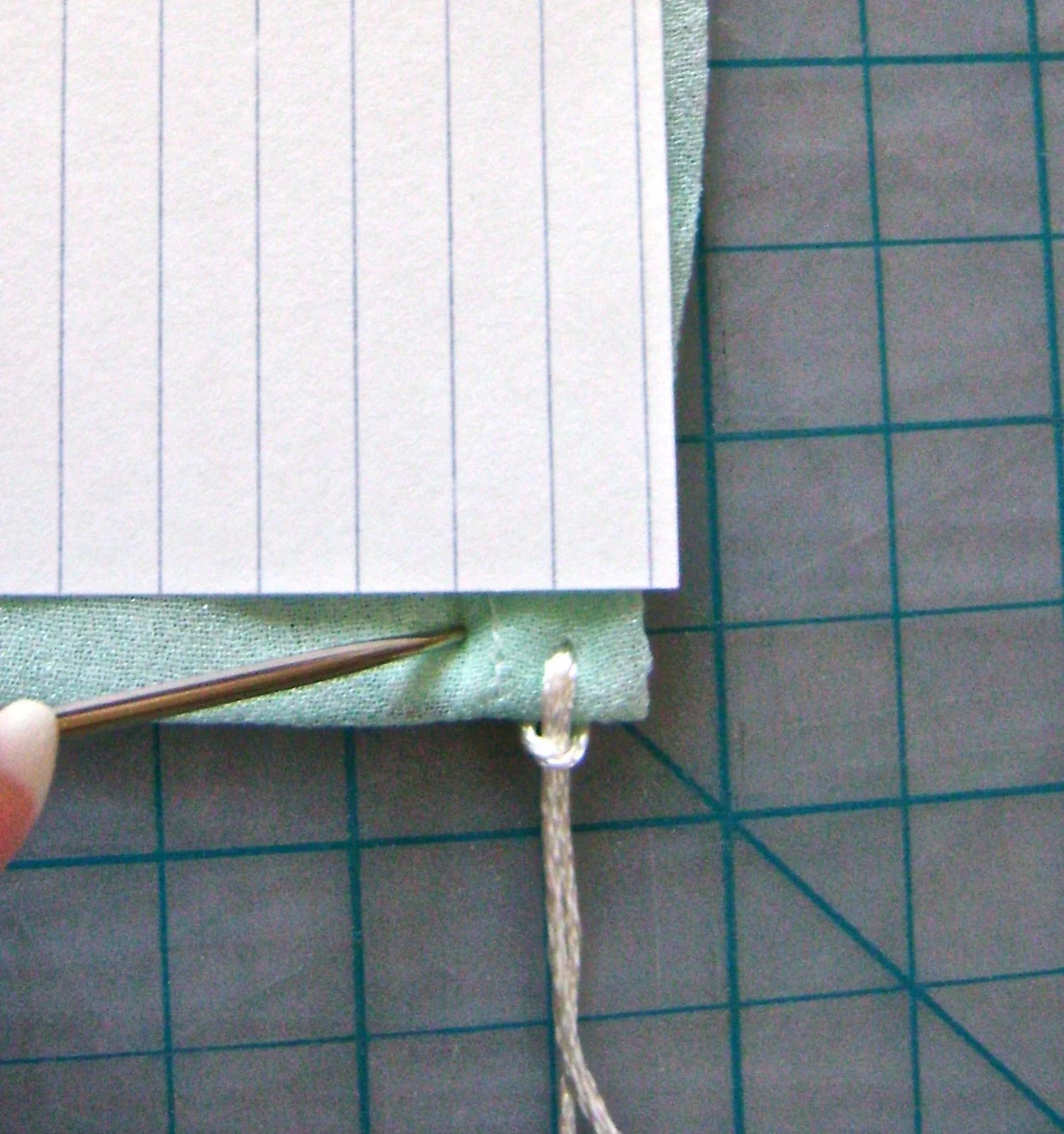 step 7 - Use the lines on a standard index card to help you space each fringe 1/4” apart. Continue adding fringe across the width of the wrap.