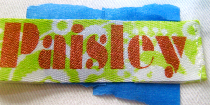 step 6 - On the right side, stitch close to the edge of the fold on one end of the label.