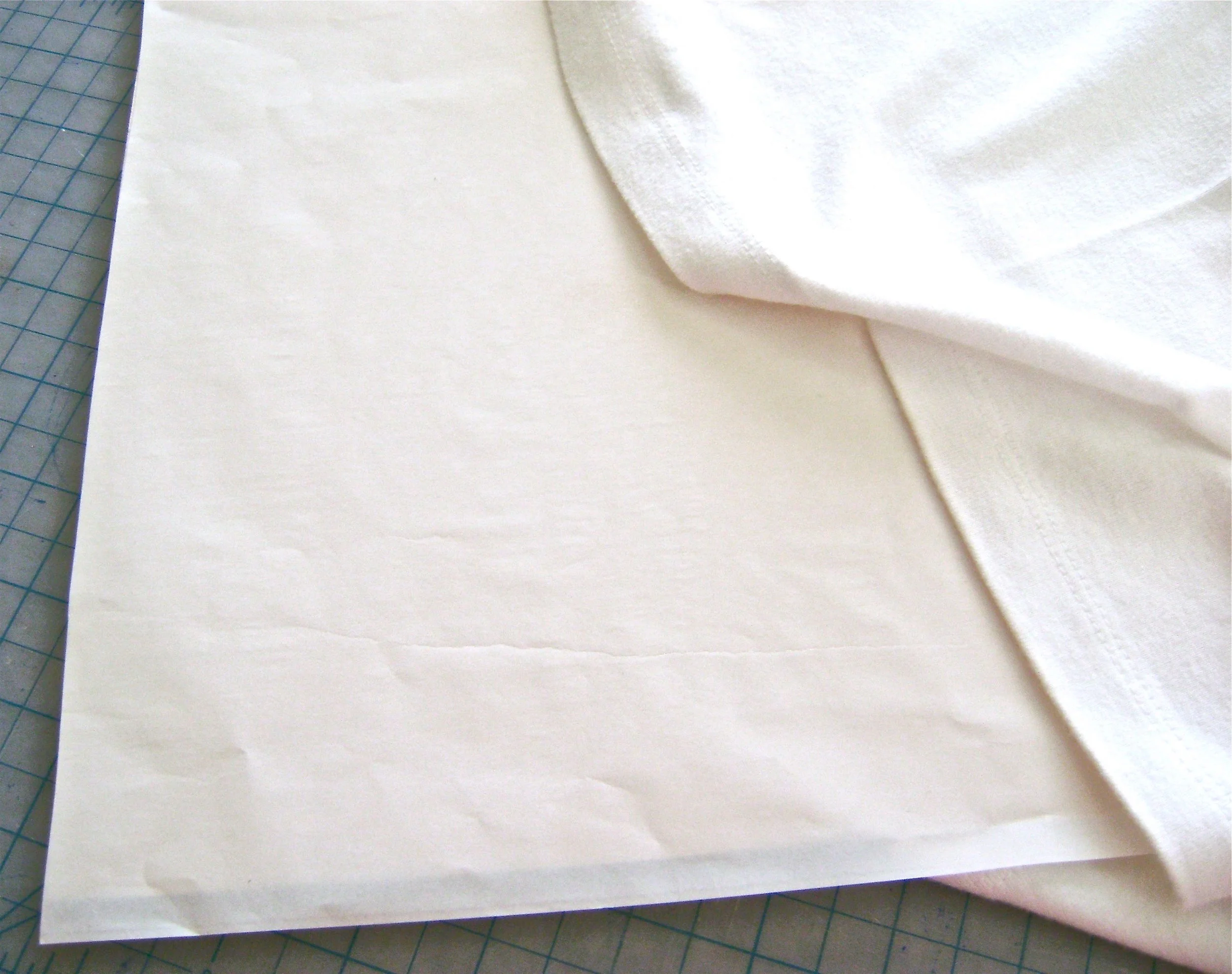 step 2 - Position the shirt on top of a hard, flat surface protected by plastic. Place cardboard inside the shirt where the design will appear. 