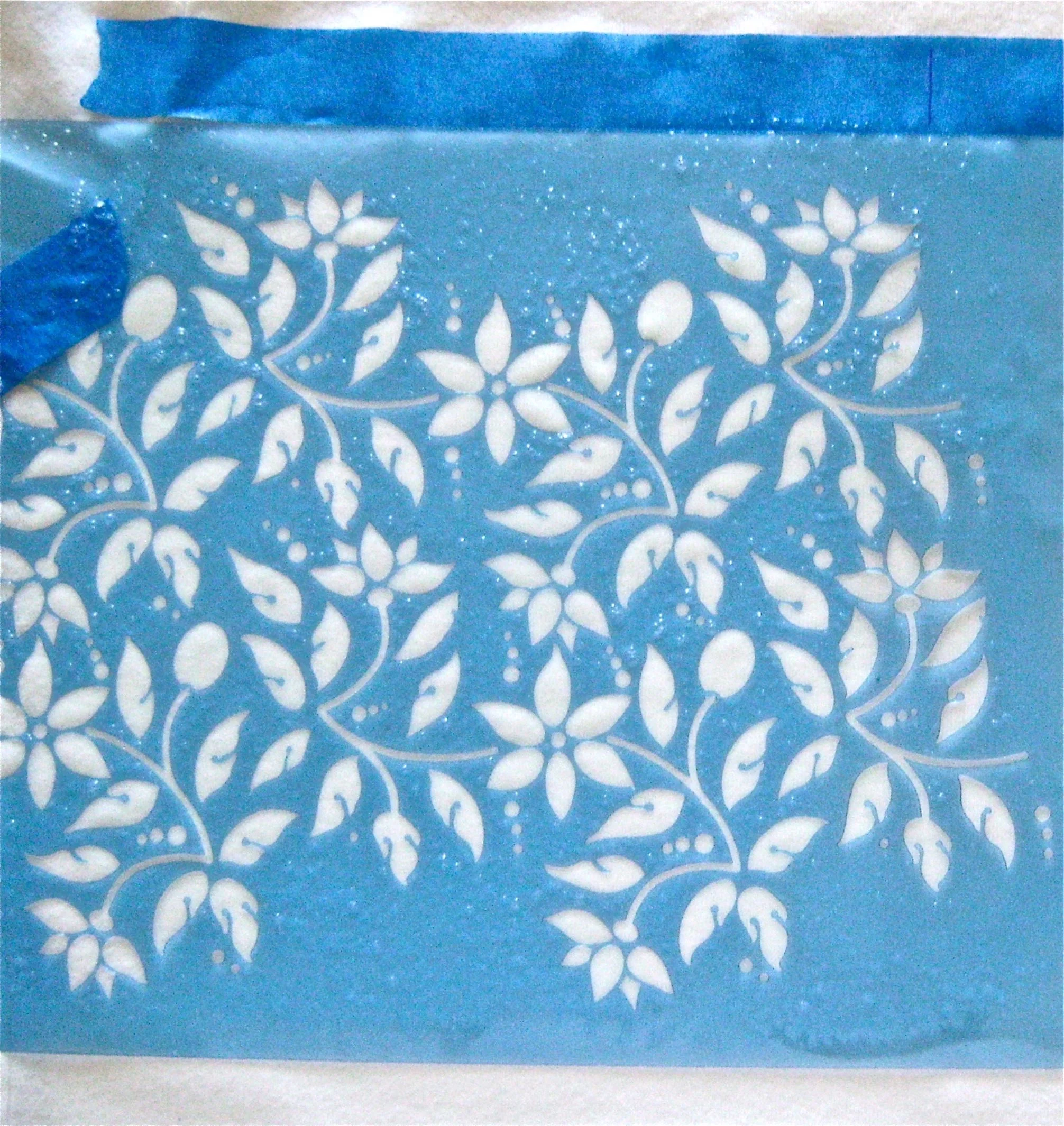 step 6 - When completely dry, remove the stencil and position it on the right side of the shirt. Align and match the left edge of the stencil’s design with the right edge of the dry design. To avoid a gap at the center, look to the pattern on the entire stencil as a guide for how to match the design. Spray the design.