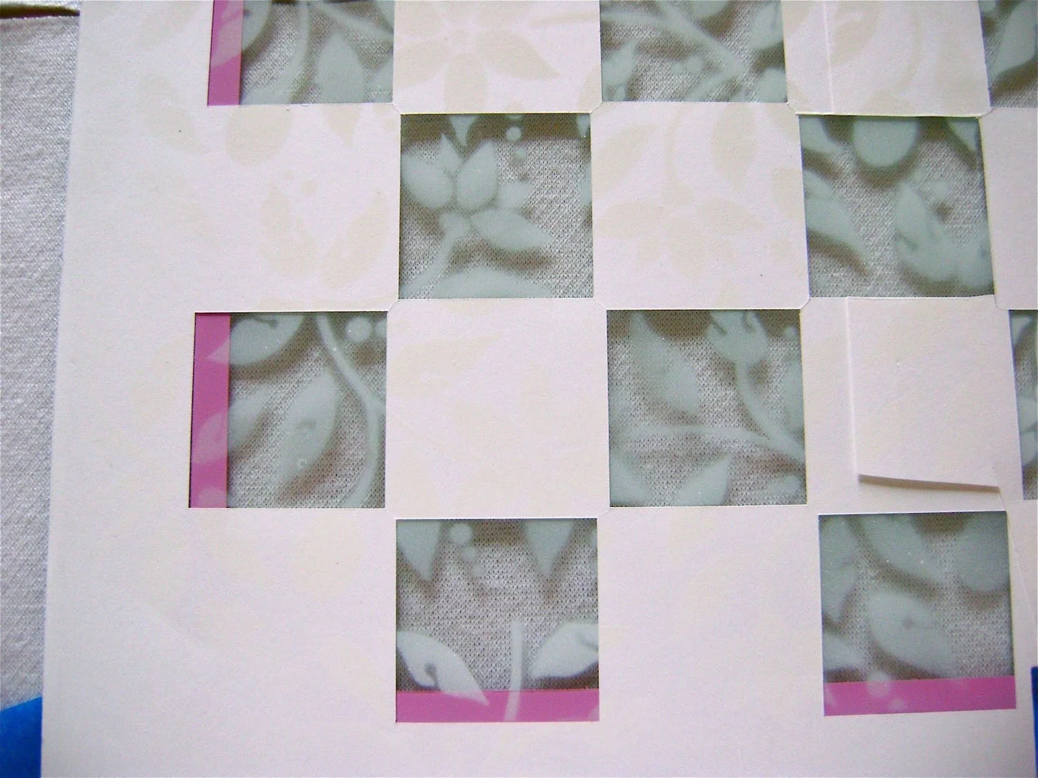 step 11 - Place the stencil over open squares and spray the glass with white paint. When all the painted leaves are dry put aside the leaf stencil.