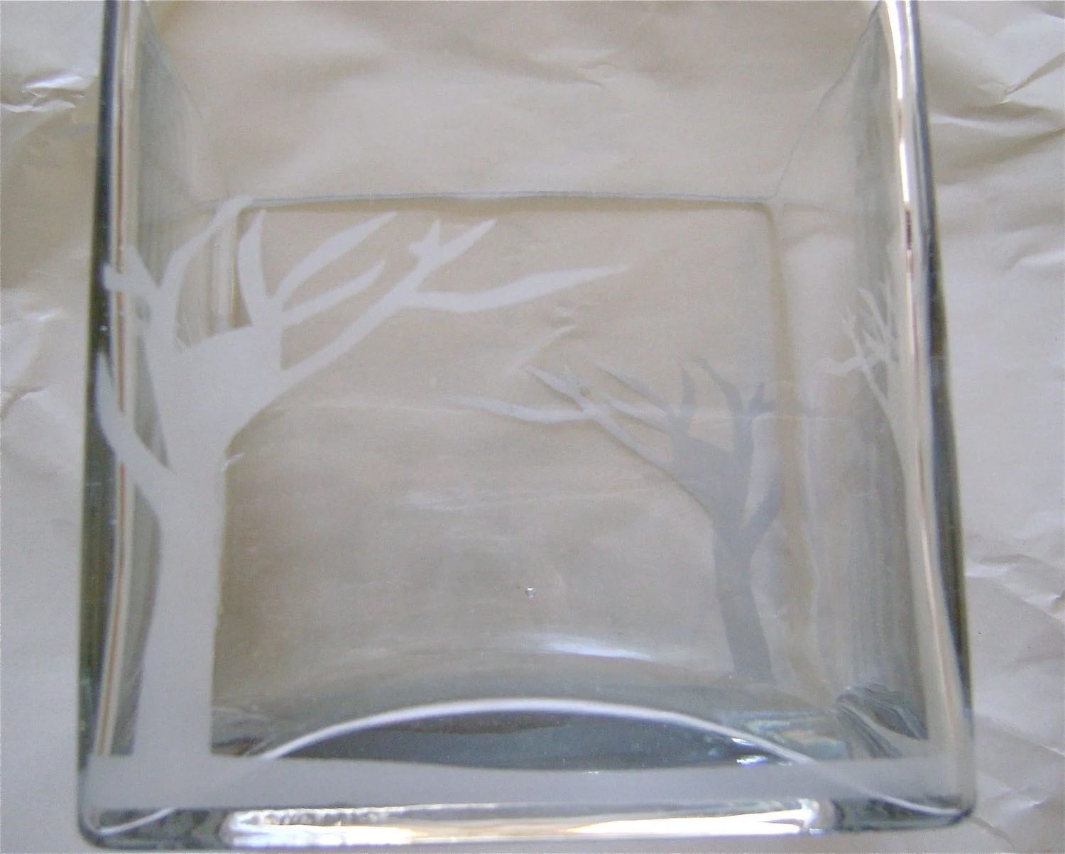 step 5 - When the paint has dried, remove the stencil. Set a soft cloth or paper towel under the cube to prevent the painted areas from scraping on rough surfaces. Turn the cube and apply the stencil and paint on the second cube panel. Avoid touching the painted areas as a slight scrape of a fingernail, may scratch the paint. Spray the remainder of the panels.