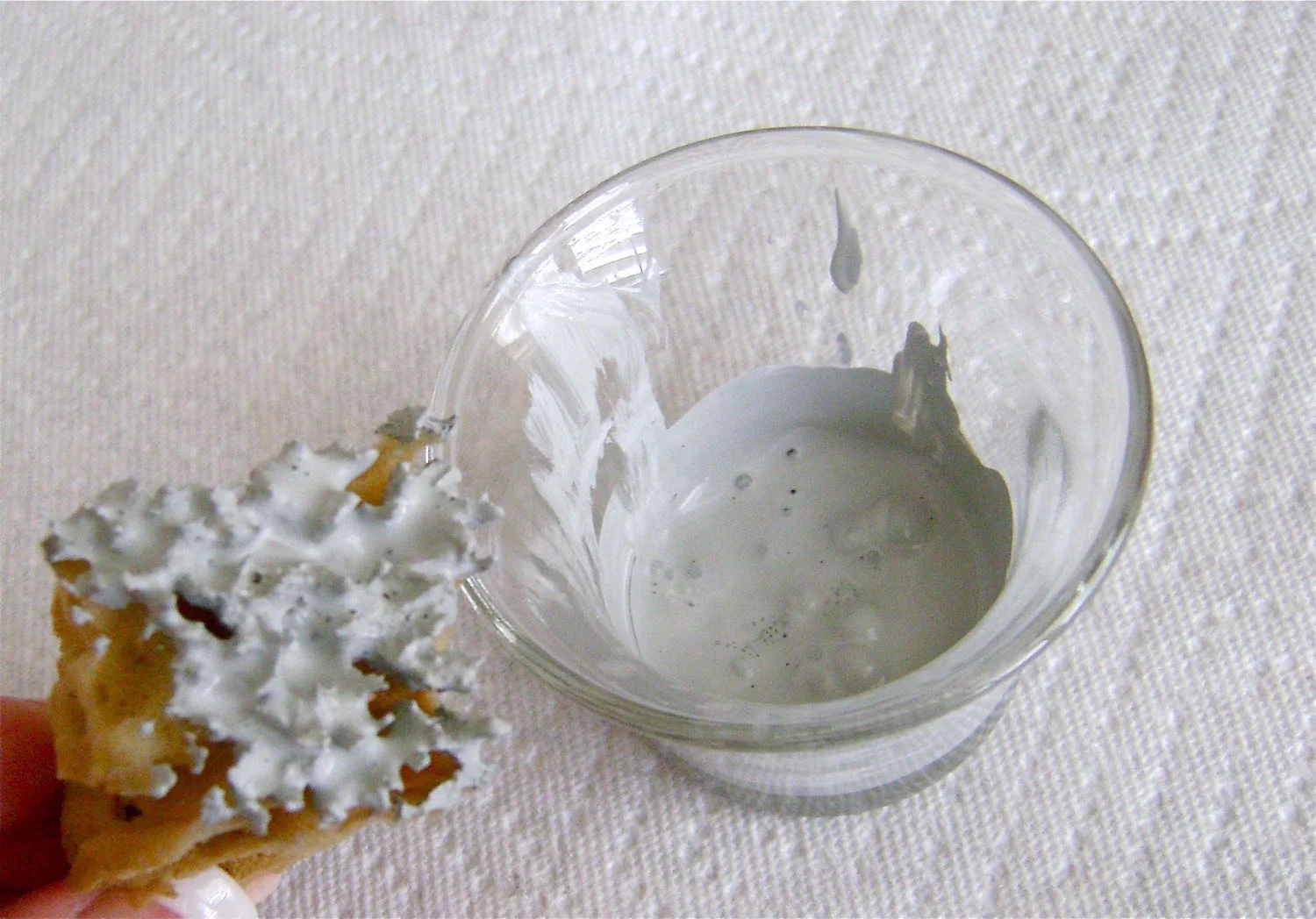 step 8 - Dip the jagged ends of the sponge into the paint. Pat it onto card stock or paper towels to remove excess paint and avoid globs or puddles when the sponge is applied to the cube. Lightly dab the sponge onto the glass to create the leaves in the tree, adding more pressure or more dabs to create dense areas. Avoid covering the branches completely or you will lose the tree’s definition. Apply the paint in this way to all four panels. If you’re unsure of the pressure you should use to apply the paint, practice on some other piece of glass.