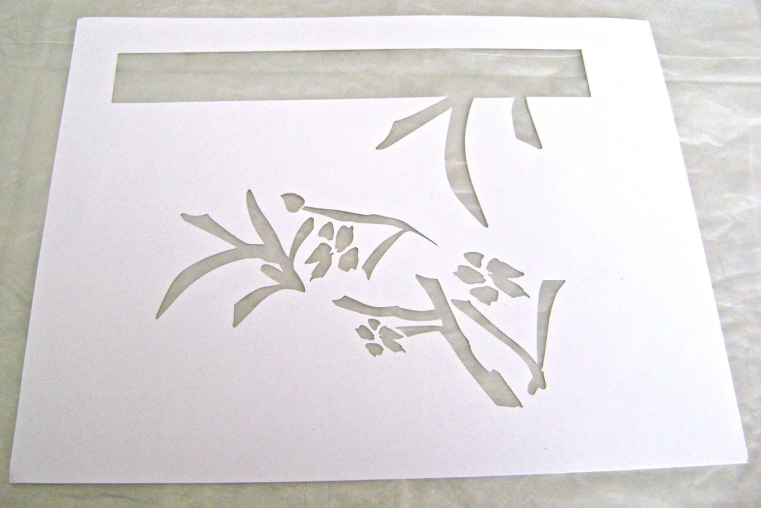 step 1 - Download and print out the flower and stem stencil on a label sheet. Cut out the stencil with a craft knife.