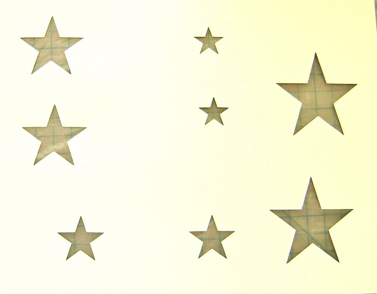 step 1 - Draw stars in three different sizes on card stock and cut them out with a craft knife.