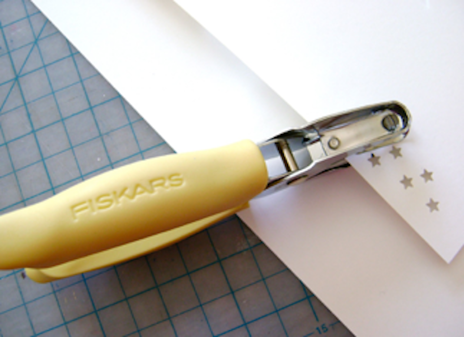 step 2 - Punch holes in a strip of card stock the same width as the hat brim, creating a stencil. Position the stars in an uneven pattern. This stencil will be used for the ribbon in step 3 and brim in step 7.