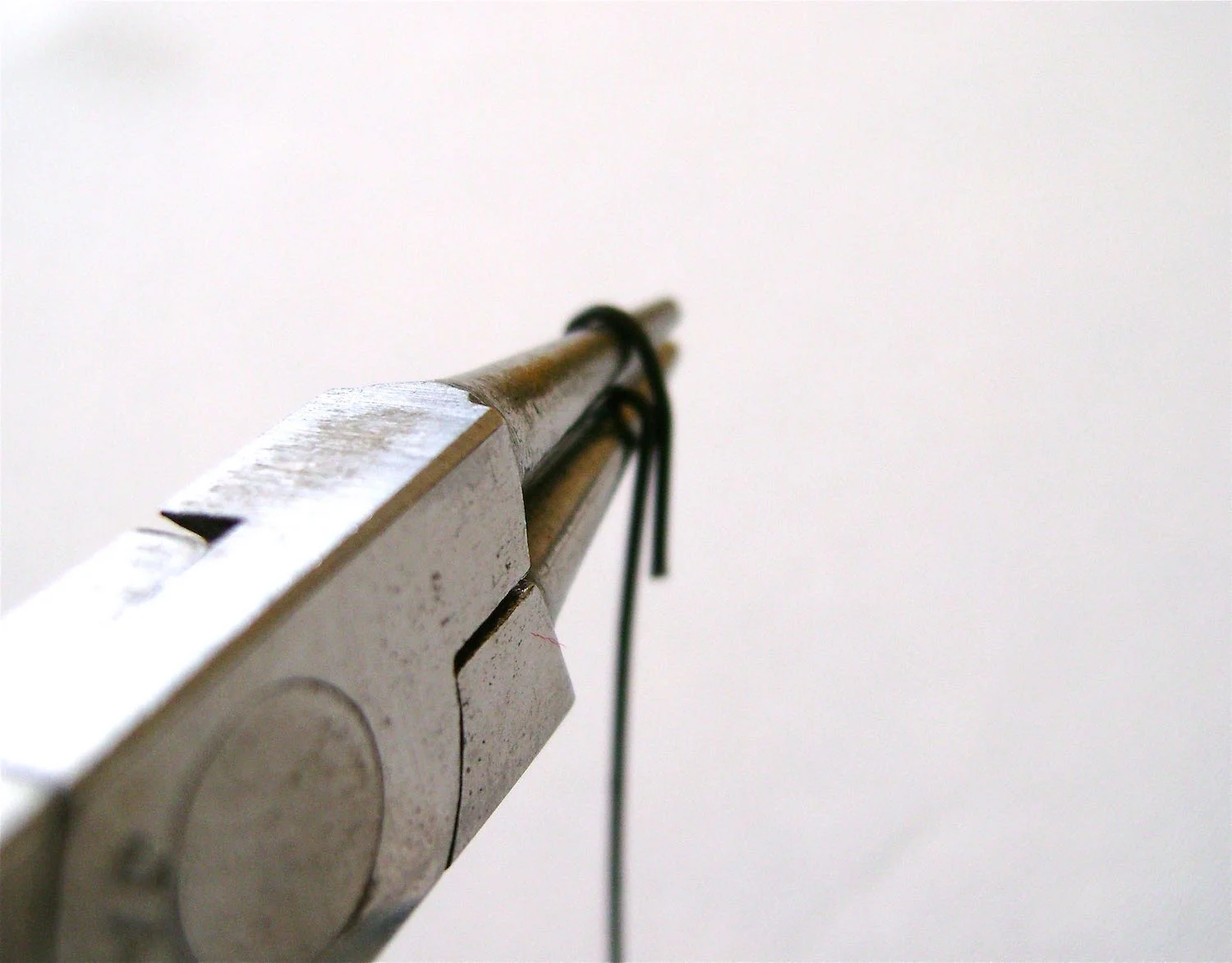 step 15 - Bend the wire down flat against the pliers.