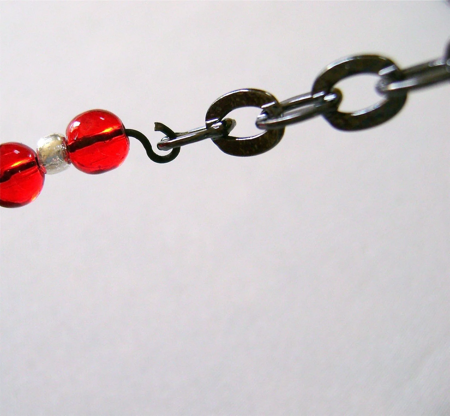step 23 - Insert the open loops of the bead sections into the end links on the chain sections and close the loops.