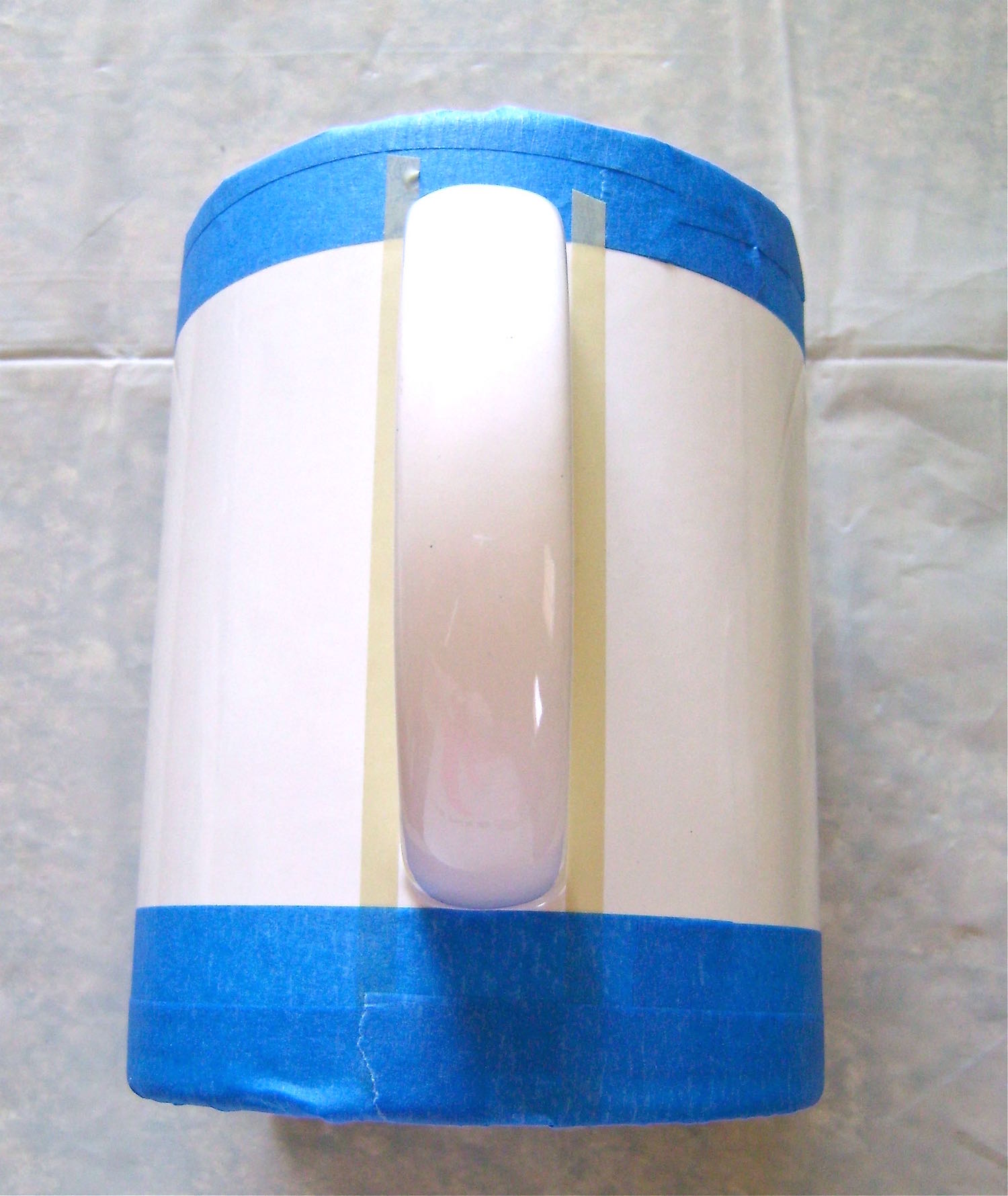 step 2 - Mask off 1” around the top of the mug and 1.25” at the bottom with the painter’s tape.