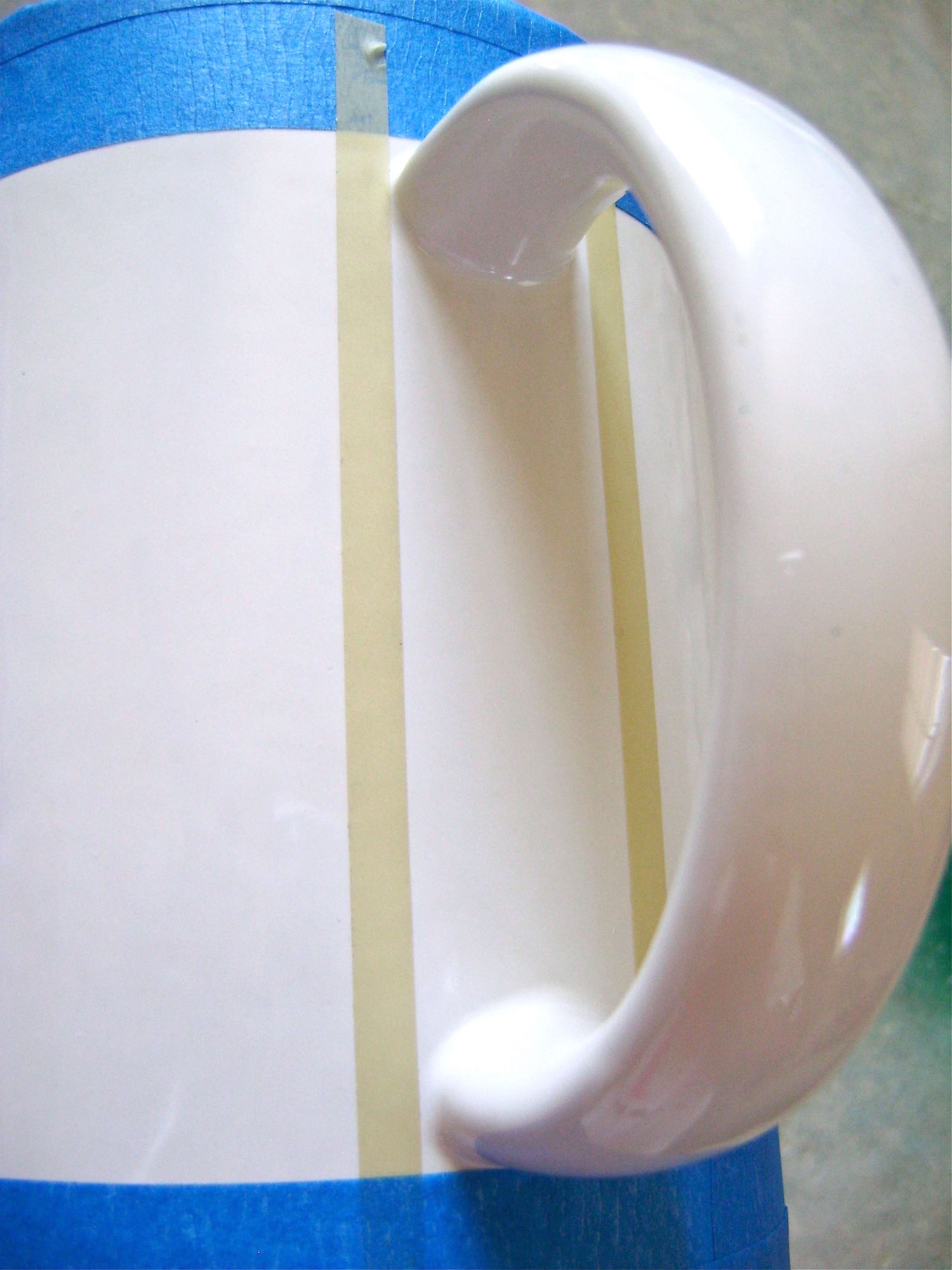 step 3 - Place ¼” masking tape vertically on both sides of the handle.