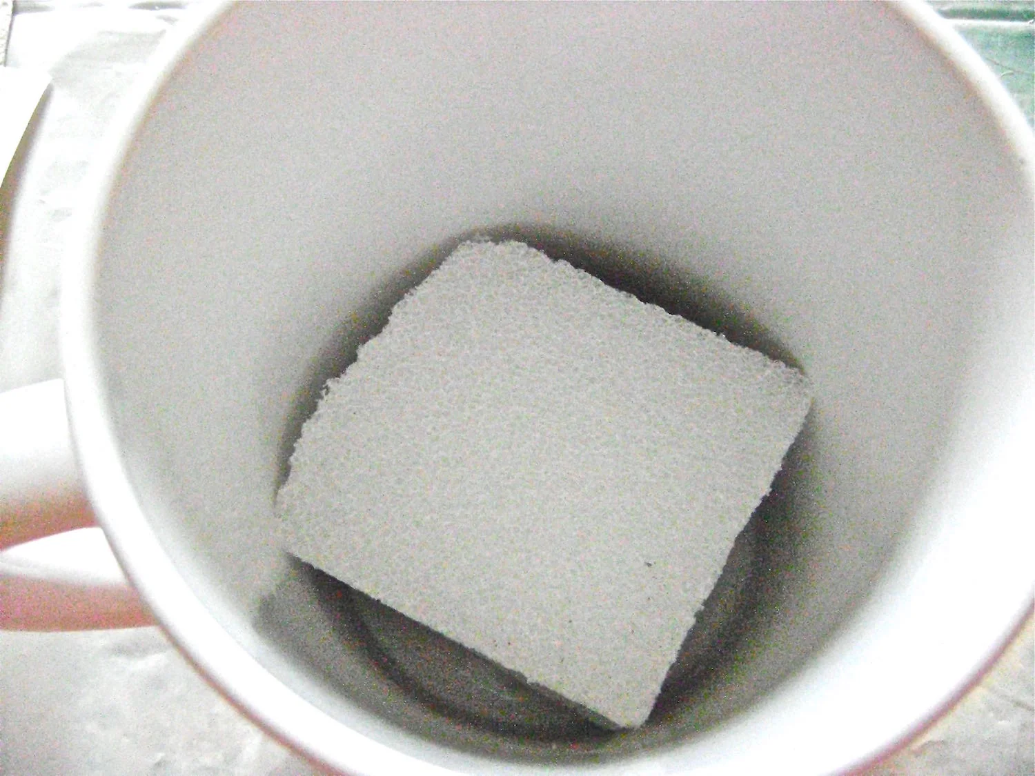 step 11 - Cut a piece of Styrofoam to fit snugly into the mug. Hot glue the foam to the bottom.