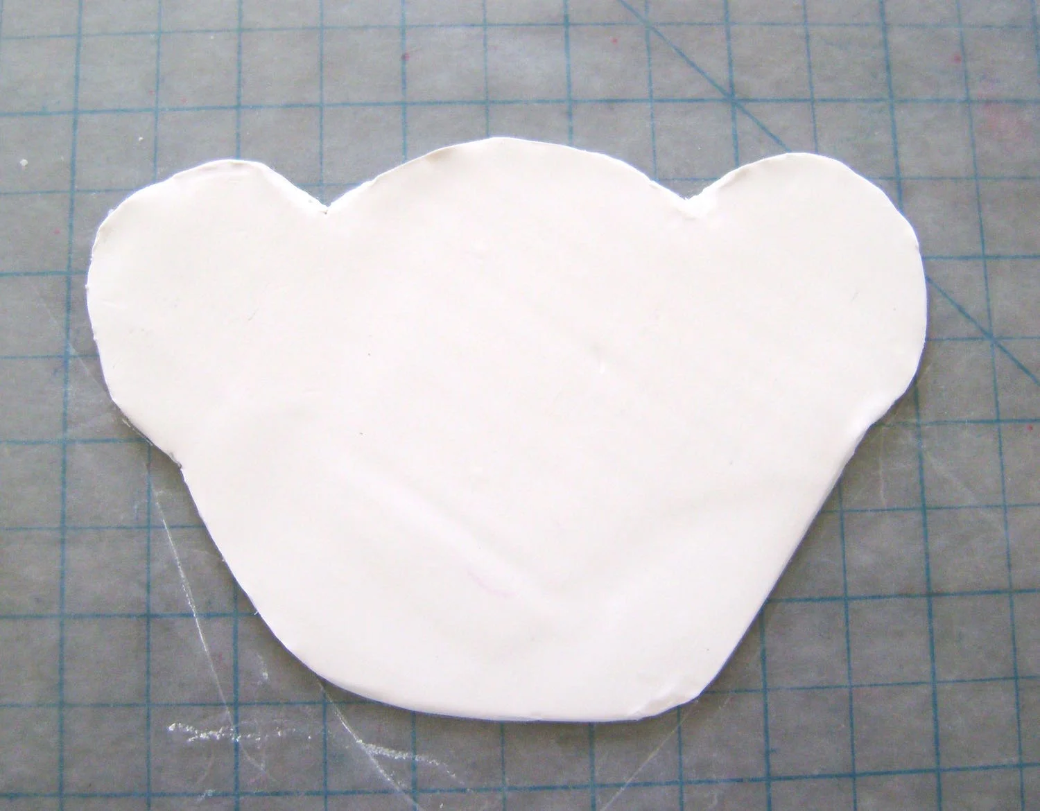 step 3 - Position the head template on the clay and cut it out using a craft knife. Cut out all the remaining pieces.