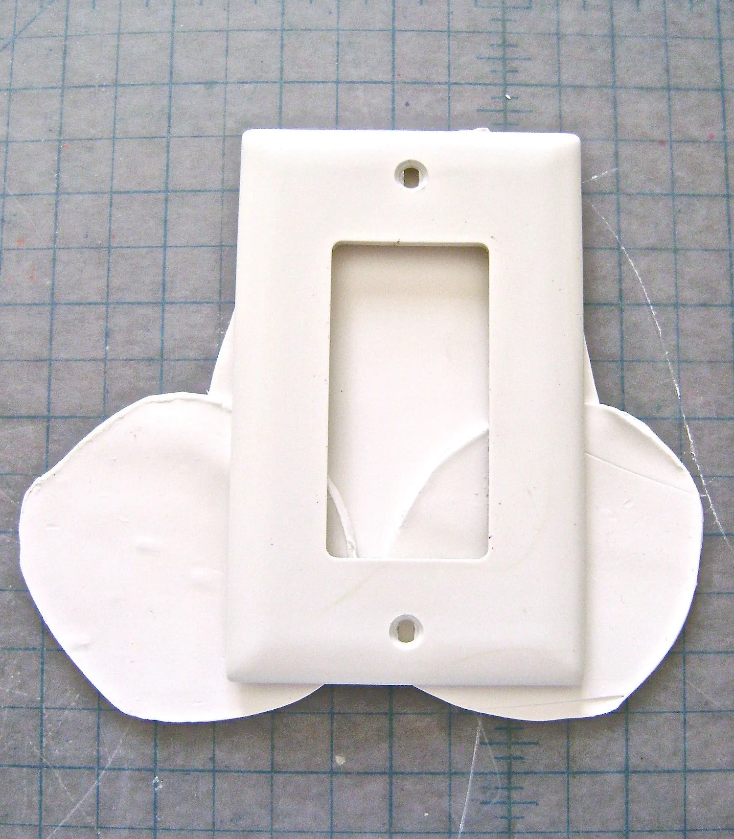 step 5 - Center a switch plate on top of the clay.
