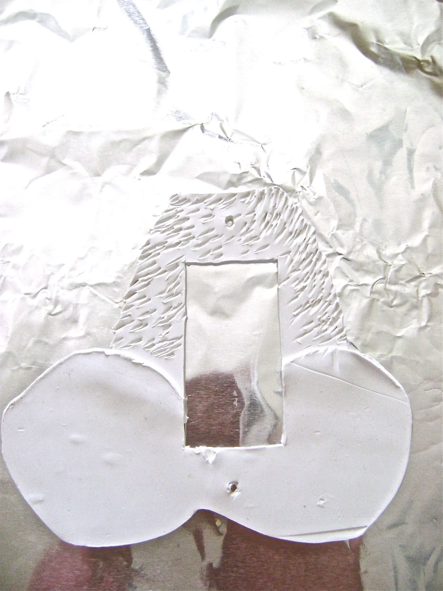 step 8 - Transfer the clay to a foil lined baking sheet using a plastic spatula. Add furry texture to the body by jabbing and dragging at it with a wood pick.
