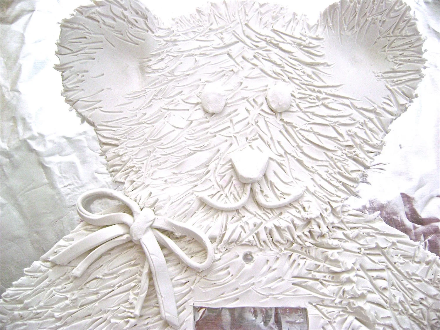 step 15 - Cut pieces of clay to add the eyes, nose, and mouth.