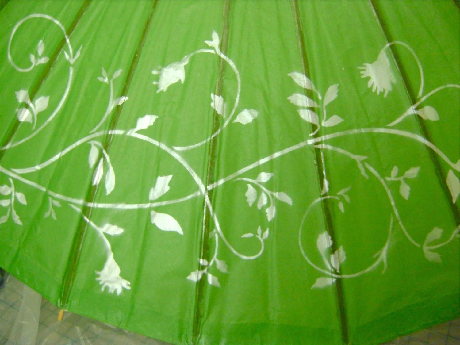 step 3 - Airbrush the stencil with white pearl paint. When dry, remove the stencil and move it to the next section. Continue airbrushing until the stencil image covers all four sections of the parasol.