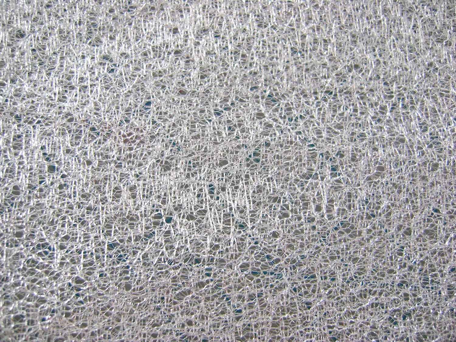 step 1 - Spray the back of the net fabric with adhesive.