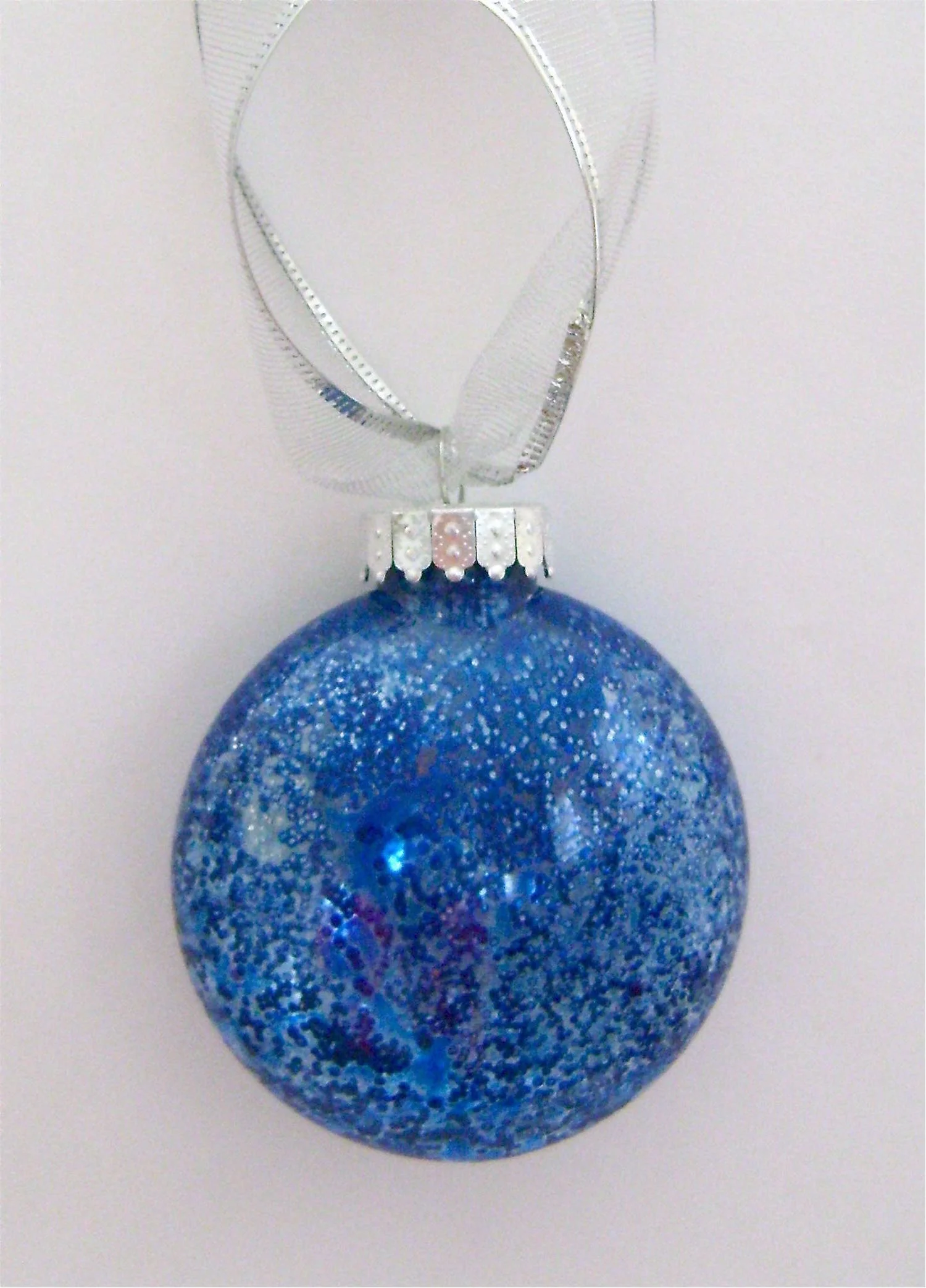 Blue Ornament Apply blue paint. When dry, quickly swish Fast Finish Decoupage around inside followed by a heavy sprinkle of fine silver glitter.