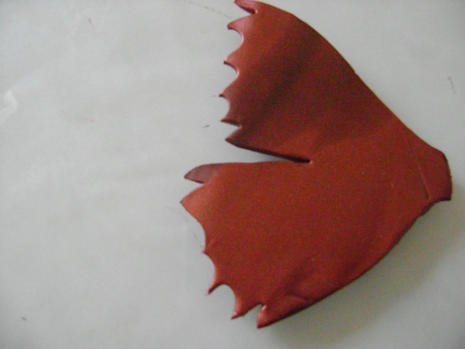 step 6 - Use mini clay cutters with diamond and heart shapes to create the jagged wing edges.