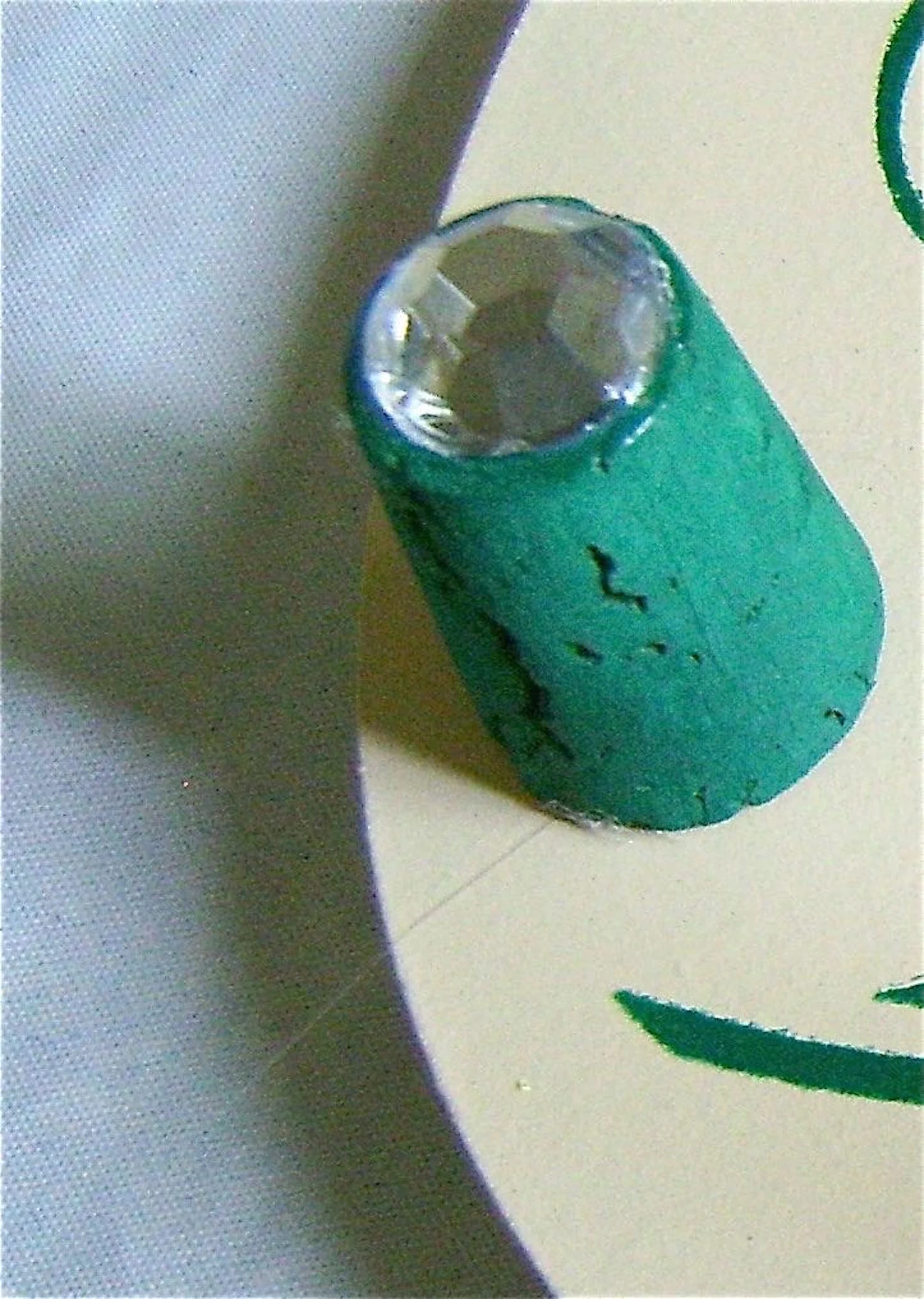 step 11 - When the corks are dry attach rhinestones to the small ends with Dazzle-Tac. Hot Glue the larger ends of the corks to the plaque.