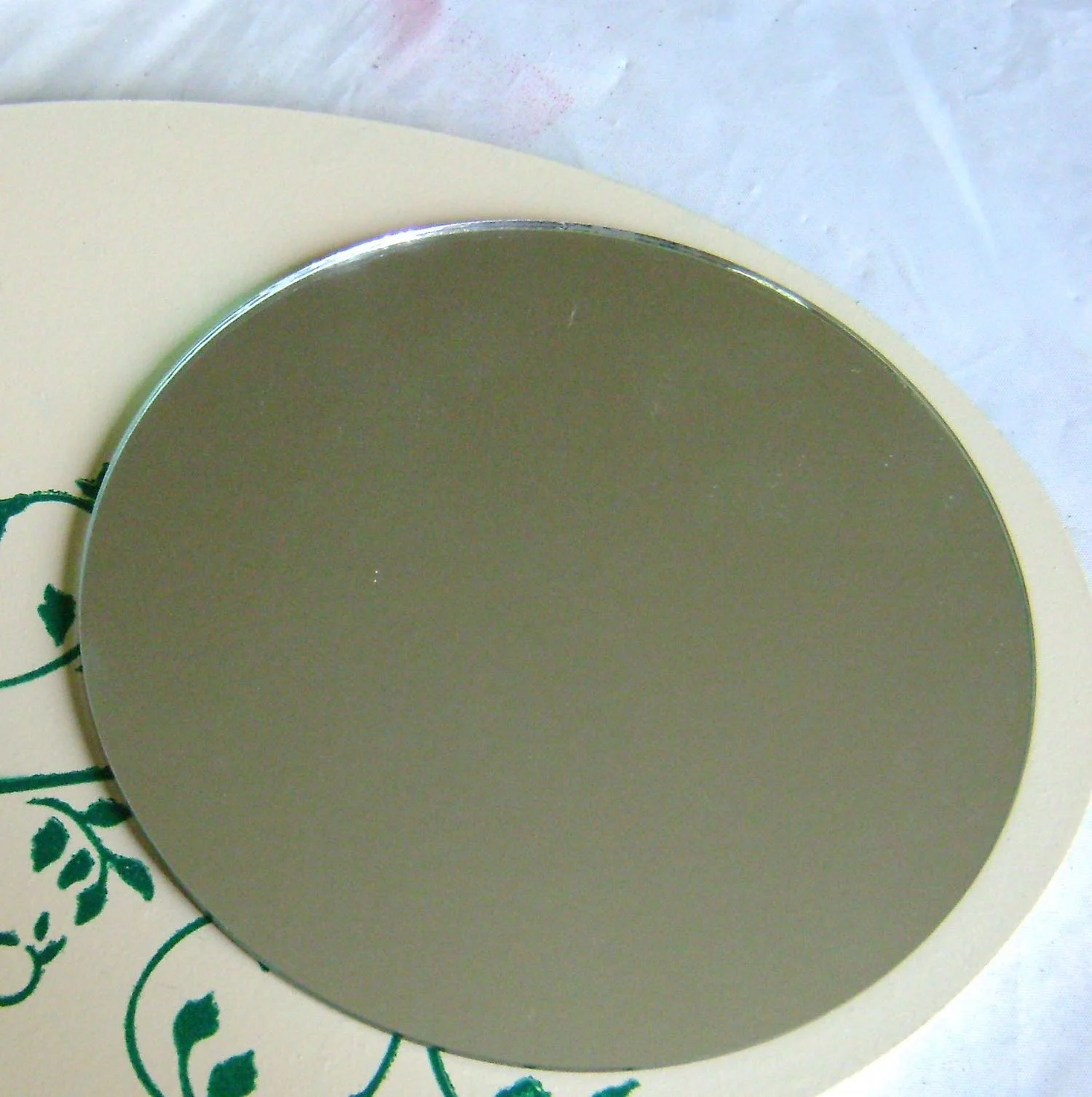 step 12 - Hot glue the mirror to the right side of the plaque.