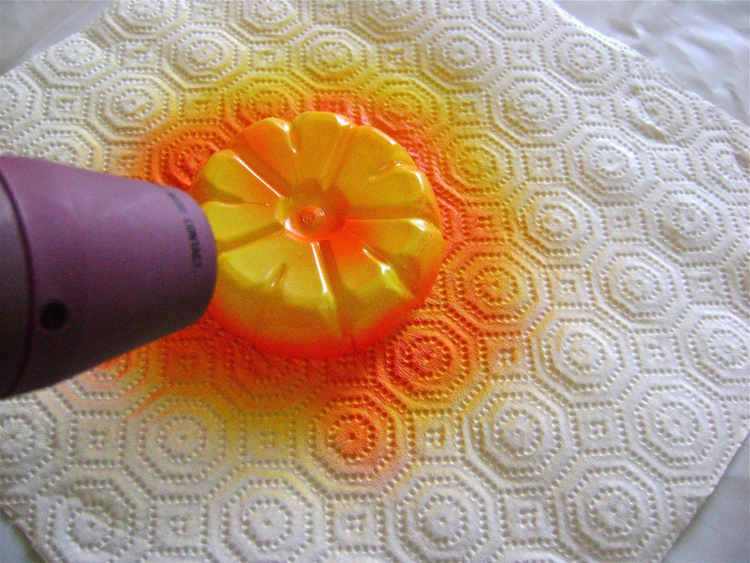 step 4 - Use a heat gun to shape the flowers. It works very quickly. Heating in short bursts close to the plastic will give you more control of the curling. Experiment beforehand on unpainted plastic to get a feel for how it will react to heat. 