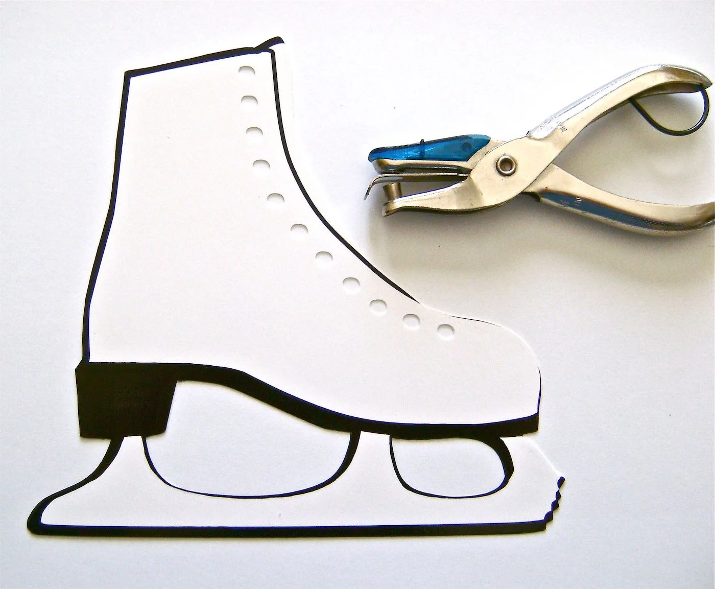 step 1 - THE SKATE Download and print out the skate image on glossy photo paper or card stock. Glue the paper to a sheet of plain card stock, which will give the skate more support. Position the glue close to cut lines so glue will remain after the skate has been cut out. When the glue is dry, use a craft knife or scissors to cut out the skate. Punch 11 holes in the skate ¼” apart as shown.