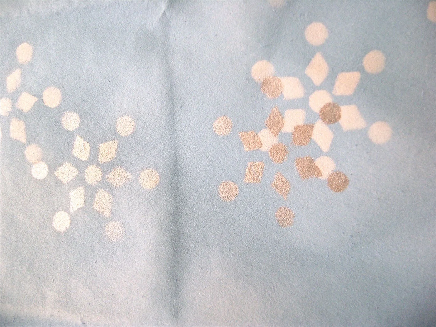 step 9 - Use one or more snowflakes, placing them randomly around the bag and masking off those you are not using. Create interesting effects by occasionally overlapping a silver snowflake on top of a white one.