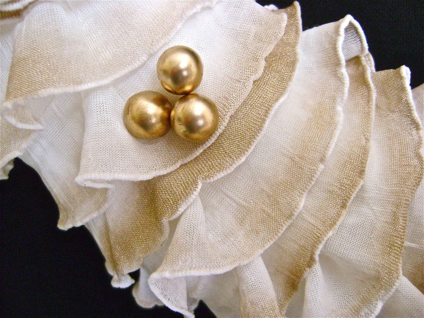 step 13 - Cut a few gold ball stems and poke them into the wreath in clusters. Dab the stem wires with hot glue before poking them through the fabric and into the Styrofoam.