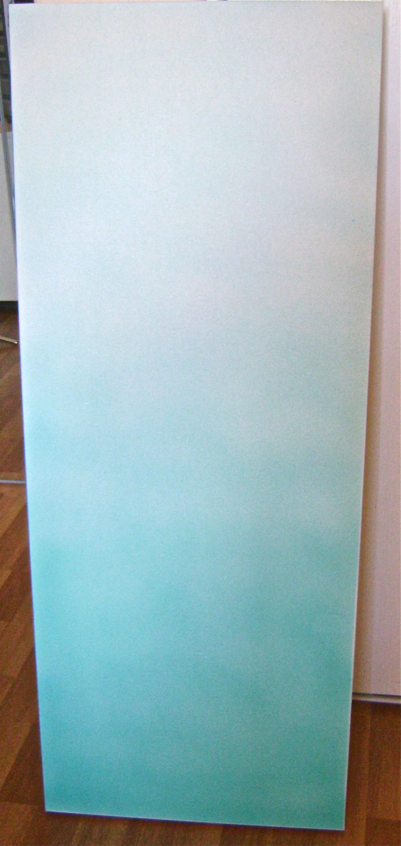 step 1 - Airbrush the canvas with turquoise paint. Begin with full color at the bottom and a progressively lighter spray working toward the top. Mix Mocha paint with white to create a light tan color. Spray full color at the top of the canvas then spray a lighter coat as you move down the canvas to blend into the turquoise. Protect the painted center when dry with Frog tape and airbrush all four sides with solid turquoise.