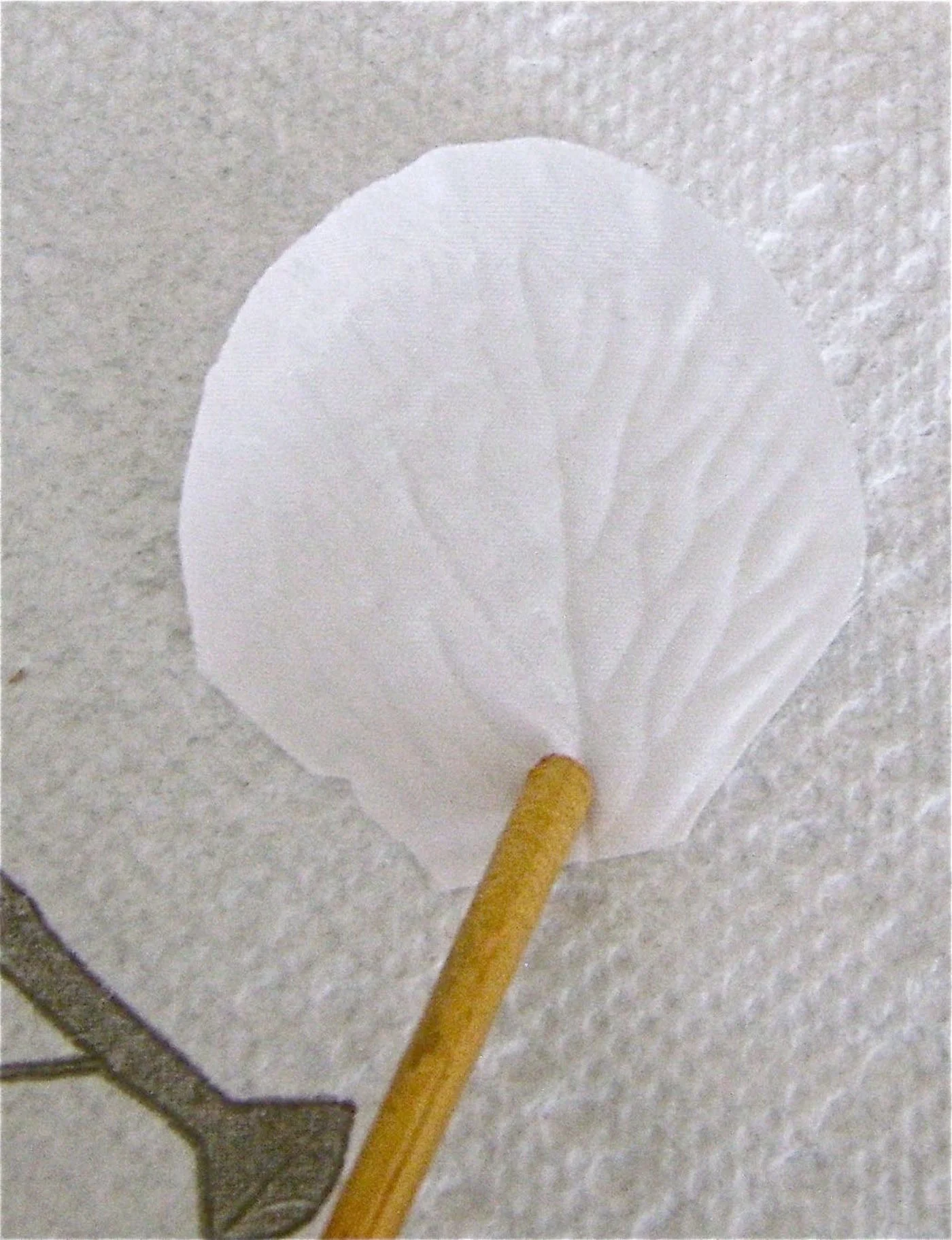 step 2 - Working over a paper towel, use a wood pick to hold down each white petal while you airbrush them. Paint approximately 80 petals using, red, orange, gold, purple and the tan color you created. 