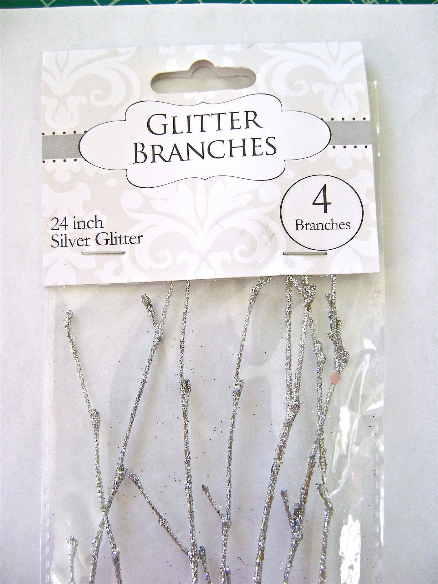 step 5 - The branches come 4 to a package and are 24 inches long. Some are fuller than others. Use the fullest branches on the upper canvas.