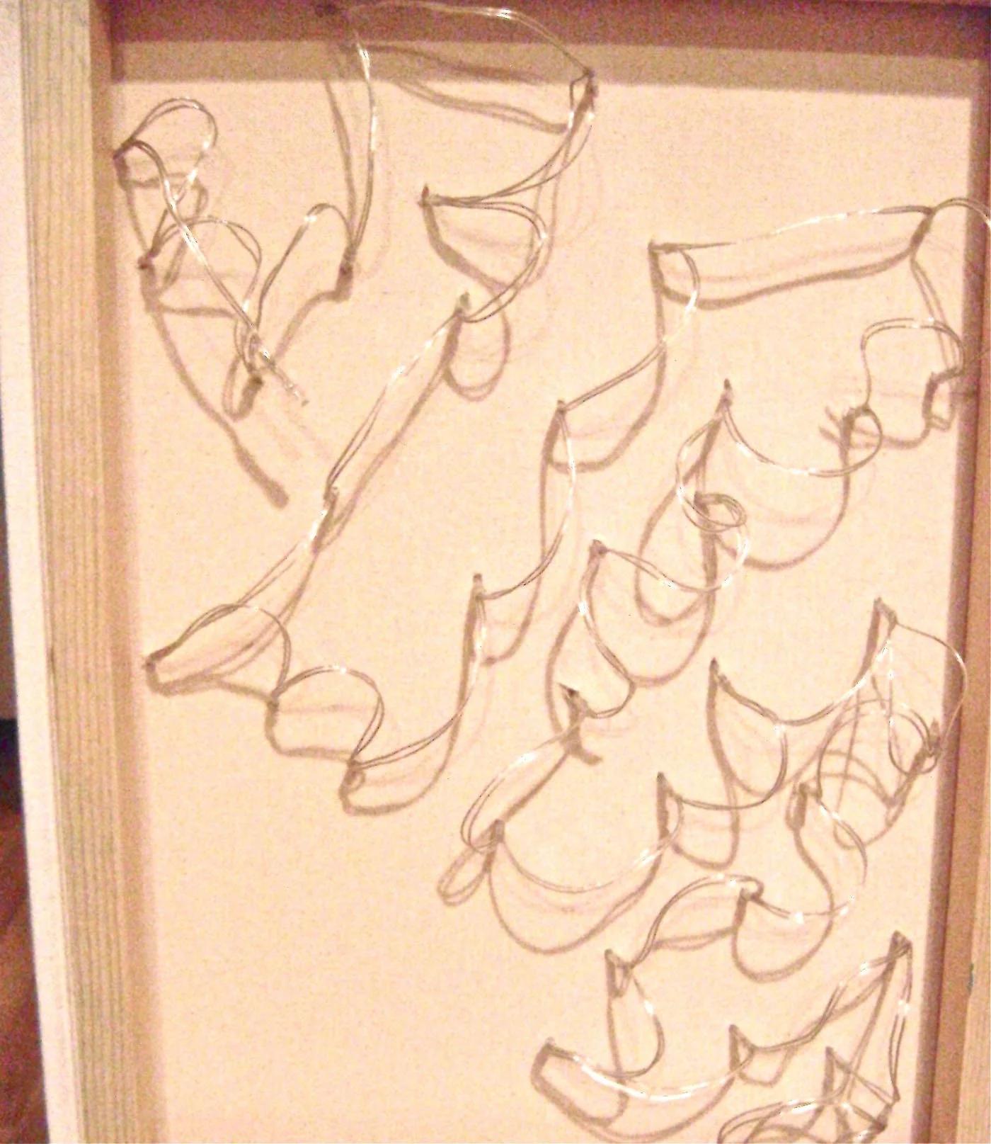 step 9 - When inserting the lights into the canvas, begin with the lower left corner. Work upward moving from left to right so that the wires won’t have to stretch to reach the next hole.