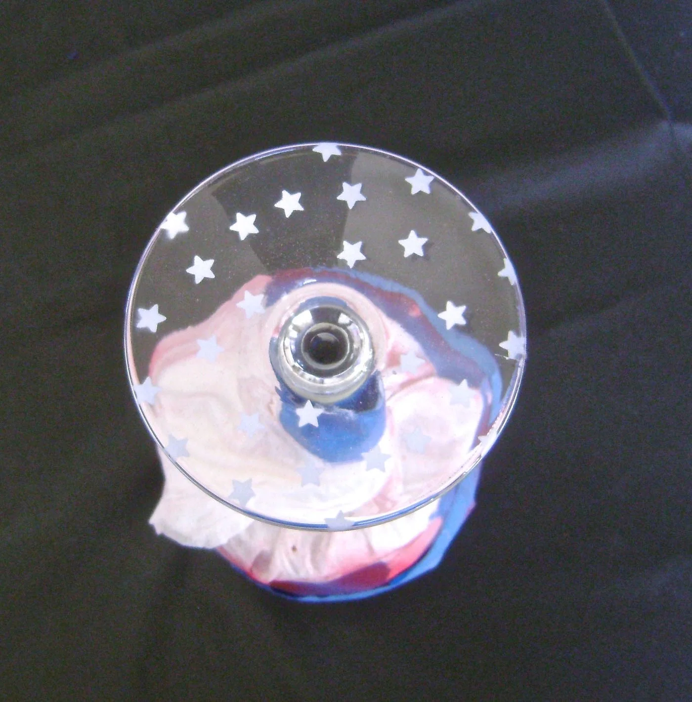 step 6 - Airbrush the stars with white paint. Remove the paper. Airbrush over the base with the blue paint.