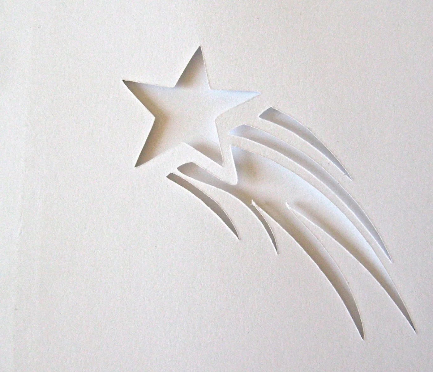 step 7 - Shooting Star Glass Cut a piece of card stock in a circle slightly larger than the glass base. Fold the circle in fourths. Use a star paper punch to decorate the circle. Apply adhesive to one side of the circle and stick it to the glass base. Protect the rest of the glass from over spray.