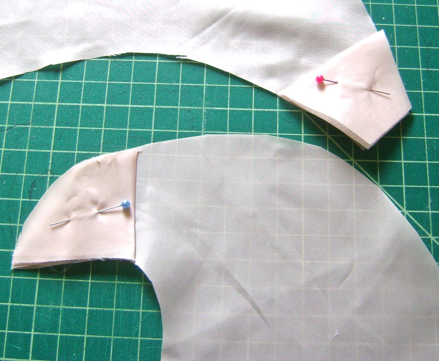 step 3 - Trace the fabric ends onto folded pieces of scraps to create facings for the top and bottom ends. They should be 2.50" deep. Iron one layer of sturdy fusible interfacing inside the folded facings. This will give added strength and support especially for the top eyelet to be attached in step 6.