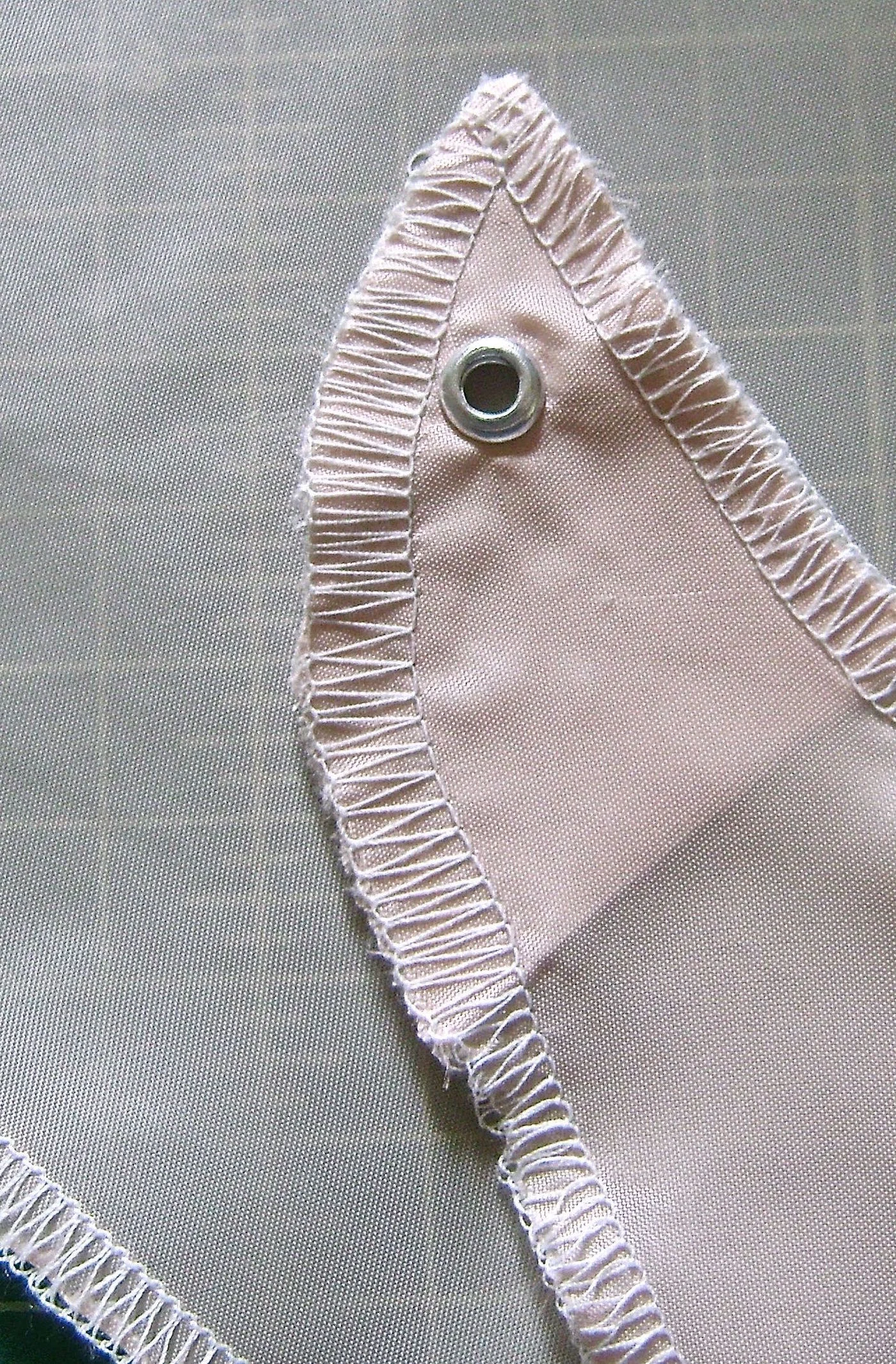 step 6 - Apply an eyelet on both panels in the center top end following the hardware instructions.