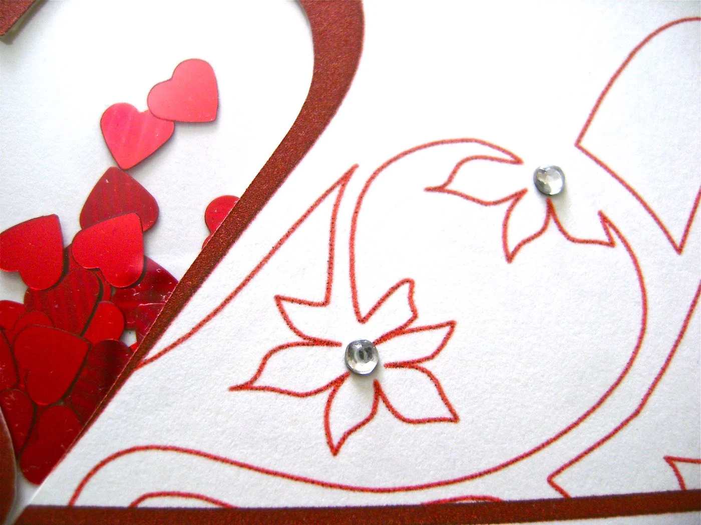 step 6 - Fold the card in half. Glue rhinestones to the centers of the flowers.