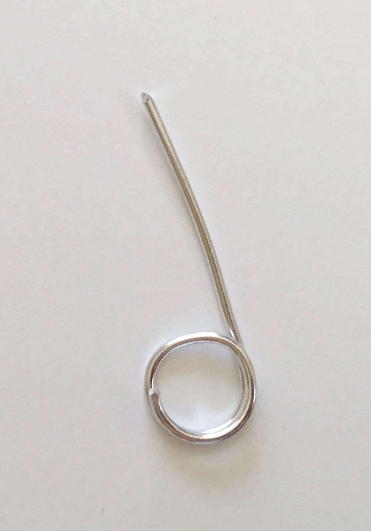 step 7 - Create a hanger by cutting a piece of 18 gauge wire to measure 2.50”. Curl one end around a Sharpie or other cylinder.