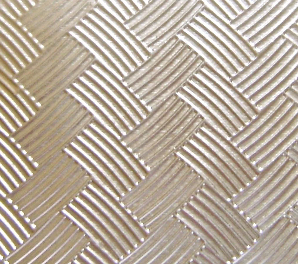 step 2 - Emboss a piece of foil that measures 3.5” square. A disposable oven pan lid is the material used for the shiny metal basket. With scissors, cut a piece to measure 3.5” square and place it into a Darice basket weave embossing folder. I don't own an embossing machine so I placed the foil in the folder and ran it through my clay conditioning machine on the number two setting. It does the job.