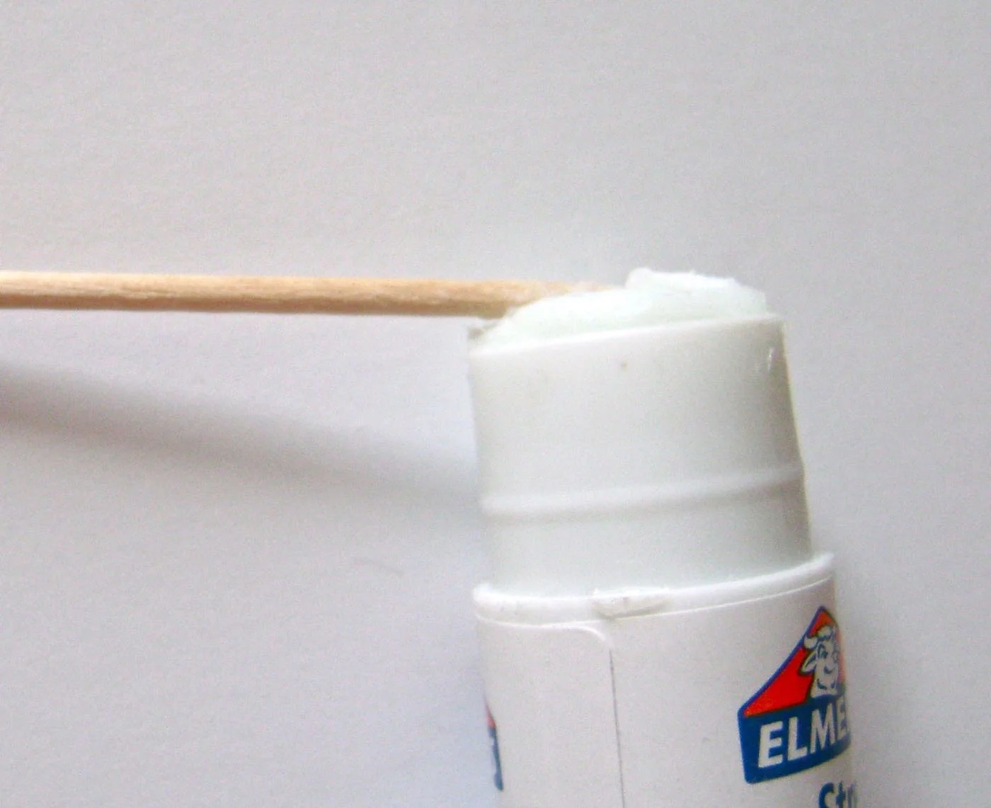 step 6 - To create the flowers, roll the top of a toothpick across the flat surface of an Elmer's Extra Strength glue stick. 