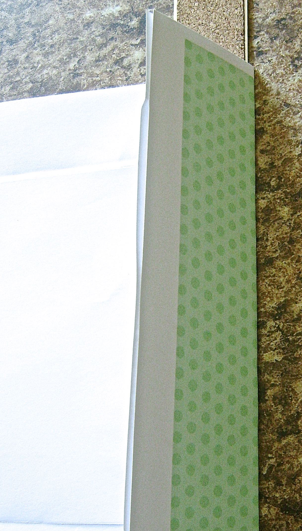 step 3 - Place the template on the backside of the color page. Turn back the template on the fold. Place a ruler on the crease and fold the color page over the ruler. Crease the color page fold. Do the same with the second vertical fold and the bottom horizontal one. Repeat with the second color page. 