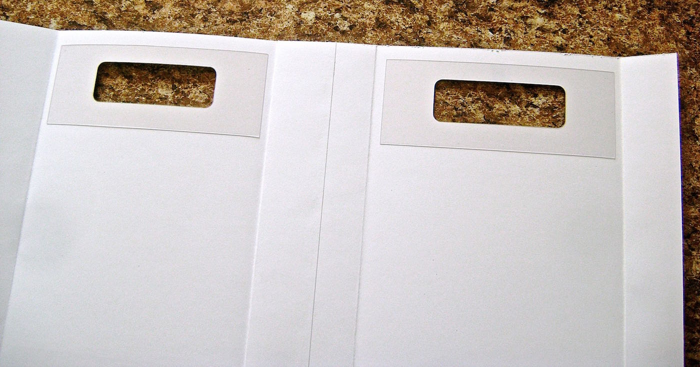 step 10 - Glue the plastic supports on the inside of the color pages aligning the handle holes.