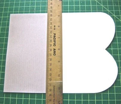 step 5 - Place a ruler on the top edge of the liner and fold the curved side of the template over it. Remove the ruler and create a sharp crease in the fold.