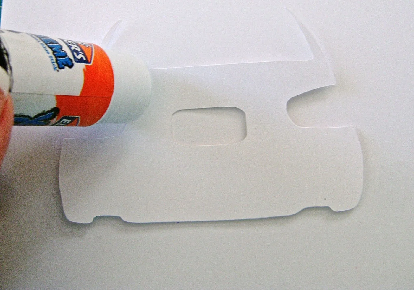 step 3 - With a glue stick, outline the car shape along with any openings, on the wrong side of the metallic cut out.