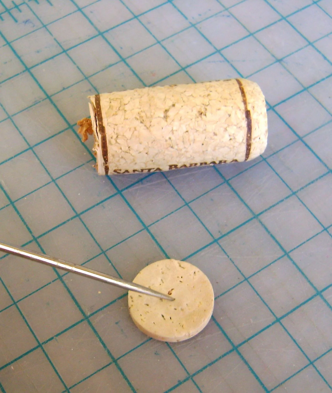step 5 - Use a craft knife to slice of a round from a wine cork that will fit snugly into a plastic water bottle cap. The round should be about 1/8” thick.
