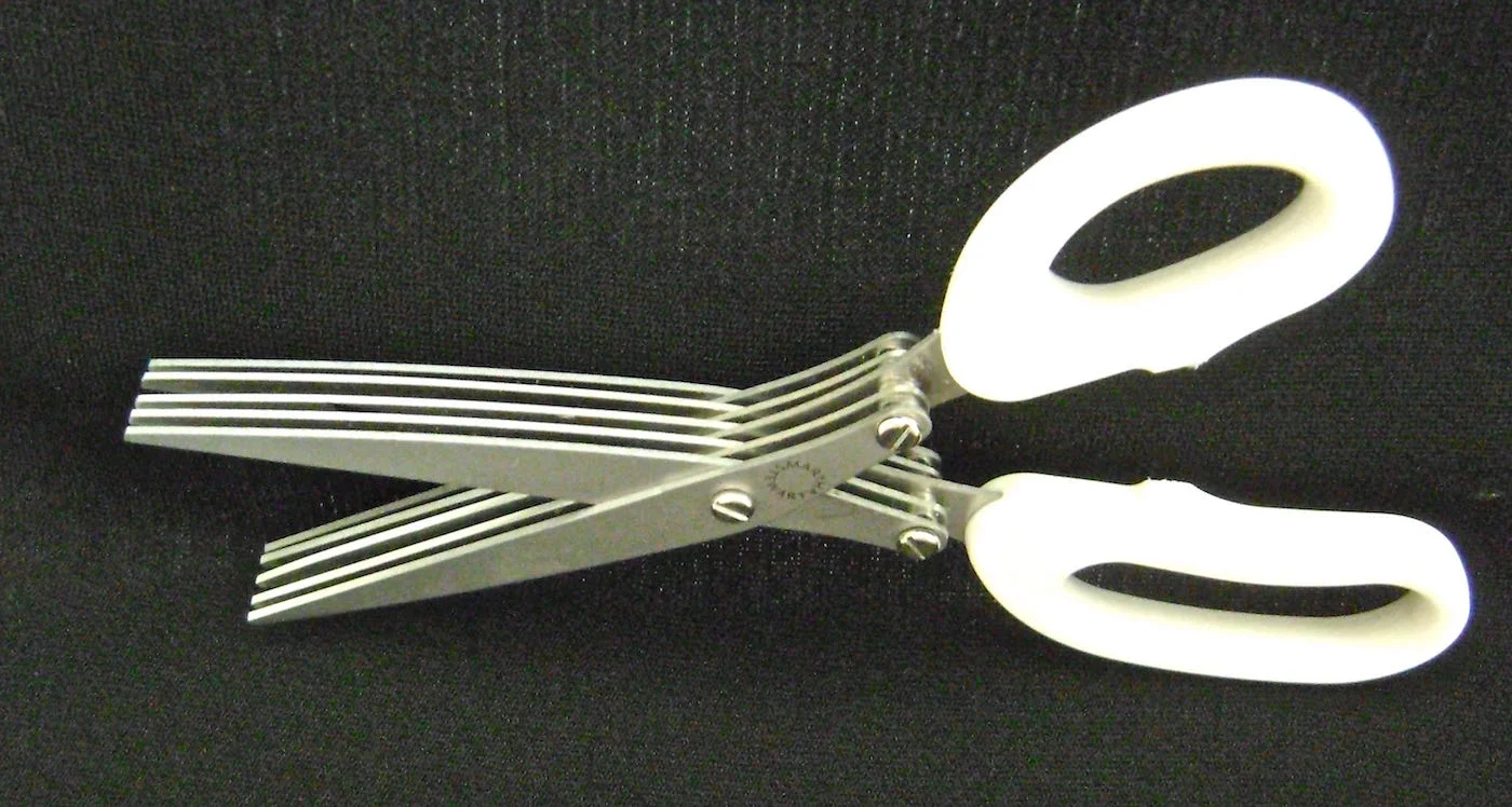 step 3 - Use a craft knife, or scissors to cut the trash bag into strips that measure 9” x 3”. It will take a little more than one bag to cover a 12” round wreath. Save cutting time by layering pieces when practical. When you have cut up one bag, fringe all the short ends using a craft knife, regular scissors or Martha Stewart’s fringing scissors pictured above. Cut the fringe to about .75” long.
