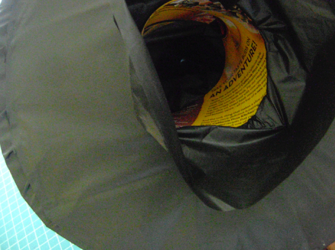 step 11 - Assemble the hat by slipping the cardboard ring into the hat top. Hot glue the ring to the plastic. Pull the excess plastic through the hole to the underside of the brim. Hot glue the plastic to the under side then tuck the excess inside the ring and glue in place.