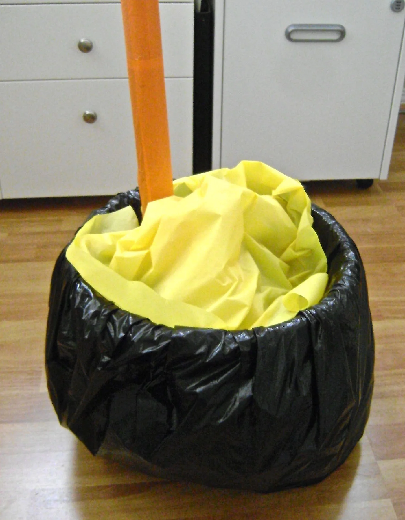 step 15 - You can leave the lights uncovered or for more color, cover them with yellow plastic. To get the stirrer to stay in position, I stuck it in my ankle weights in the bottom of the container.