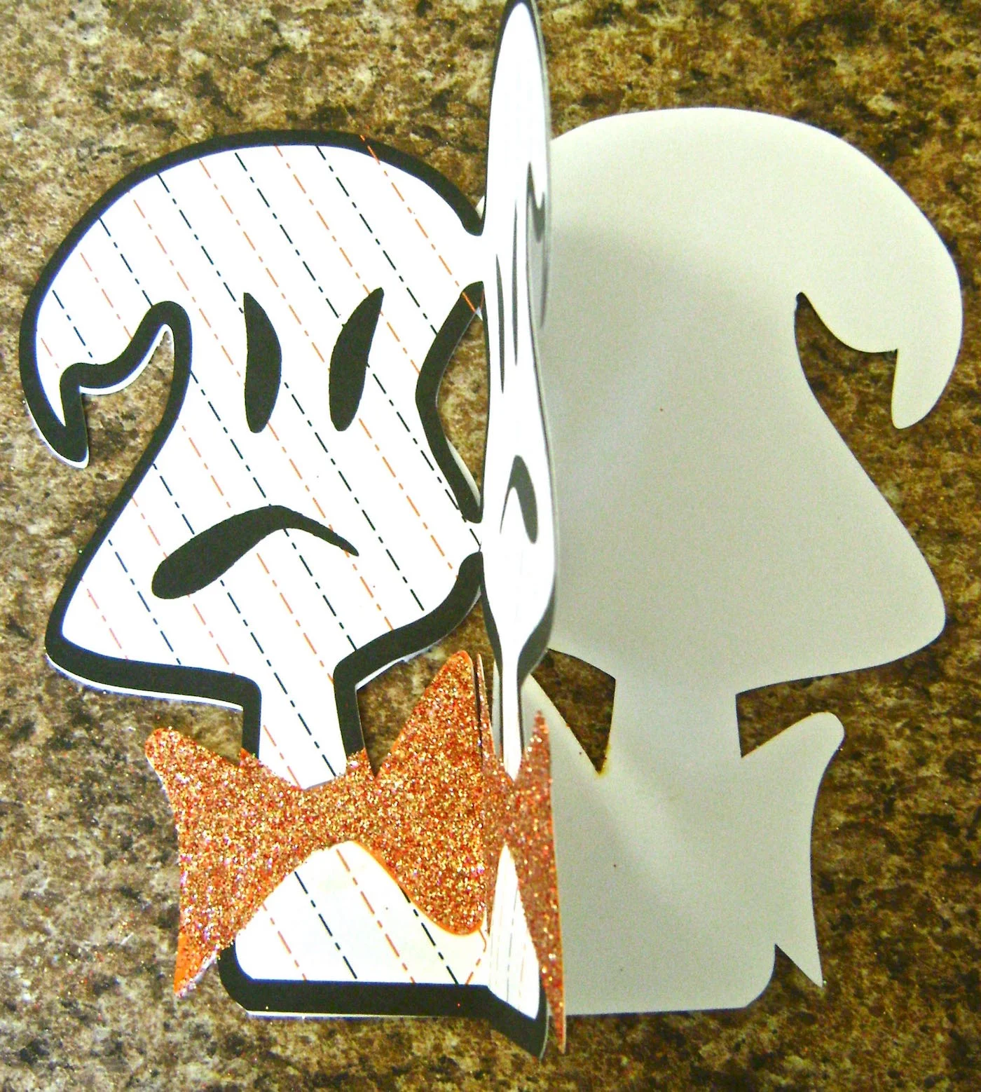 step 8 - Attach the sticky ghost to the blank side of another ghost. Once the glue is set, attach another two ghosts together. Continue to add ghosts until all five are connected.